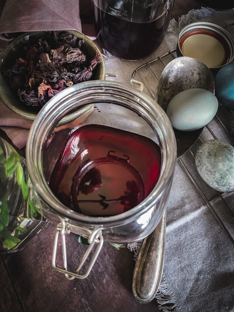 Glass jar with dye and Easter eggs