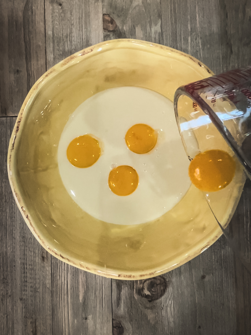 sweetened condensed milk in a bowl with egg yolks