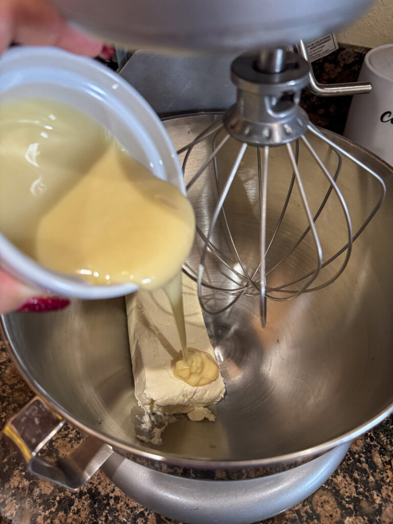 cream cheese and sweetened condensed milk in a mjxer bowl