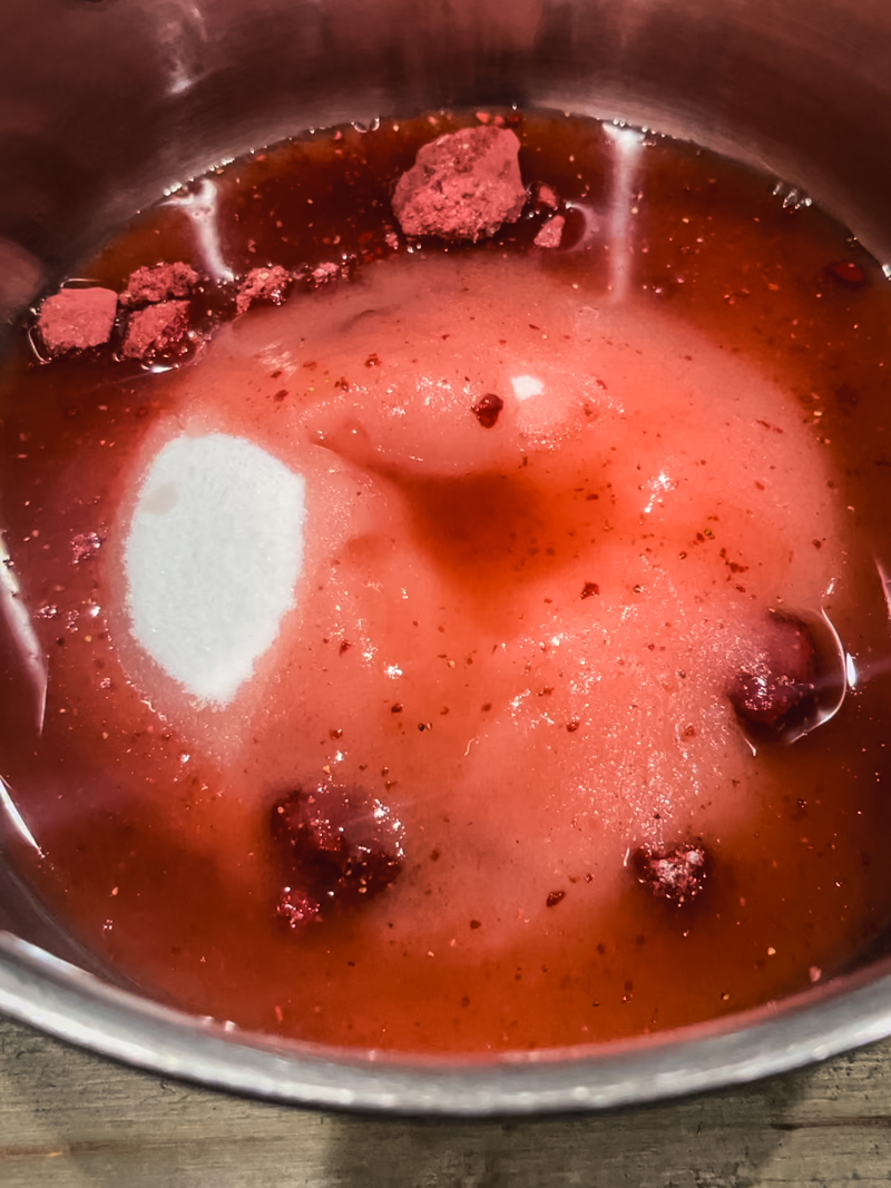 frezze dreied strawberries with sugar and water in a pot