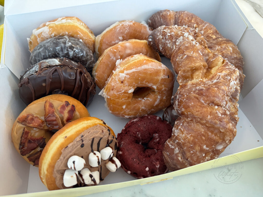 box of donuts with glazed croissants