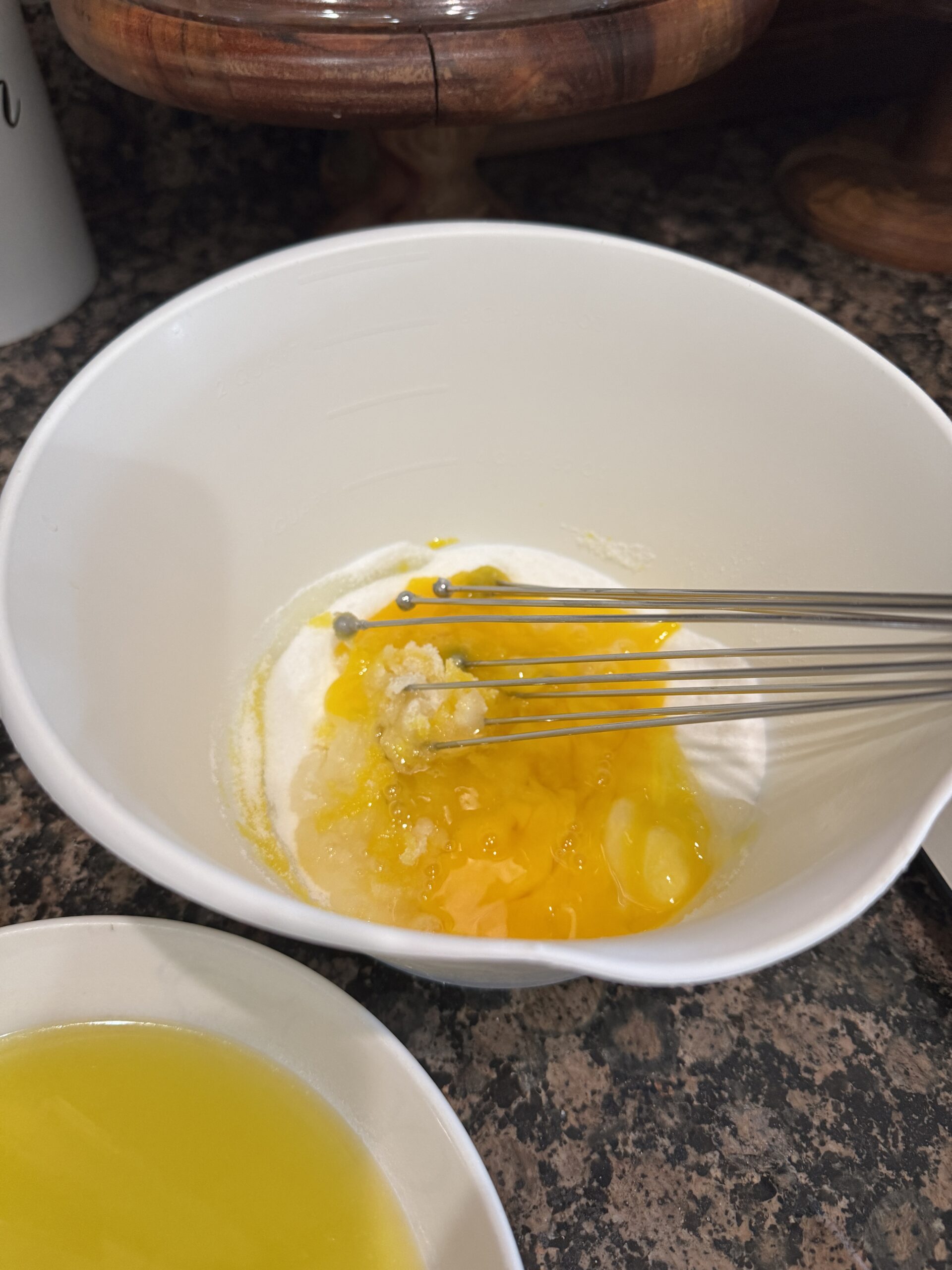 Eggs and sugar being whisked together in a bowl.