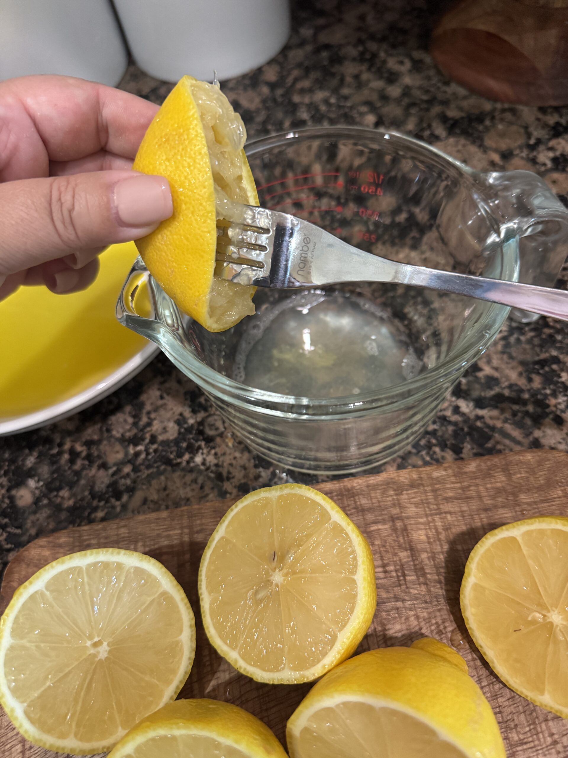 Juicing half a lemon using a fork