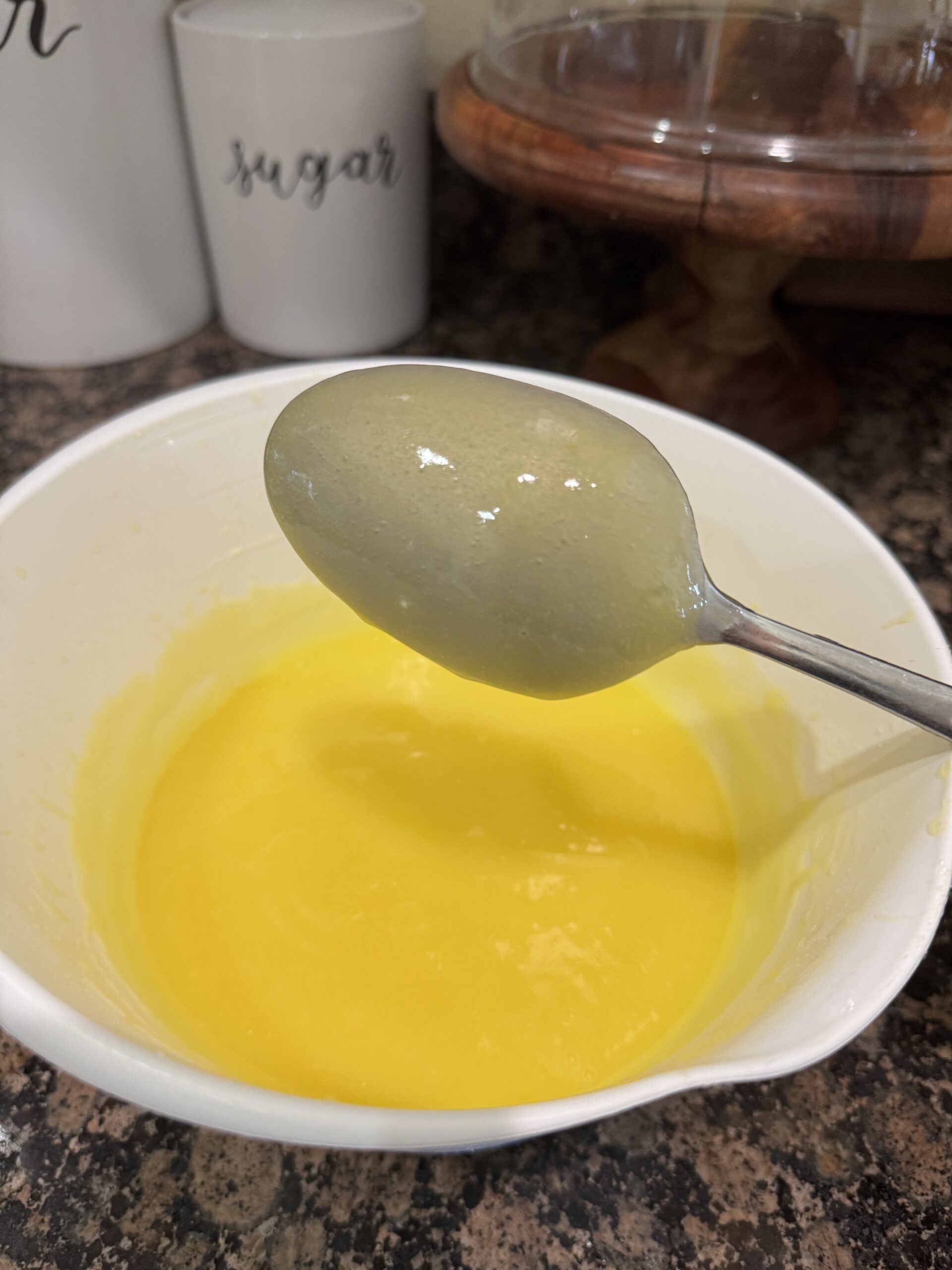 Lemon curd coating the back of a spoon