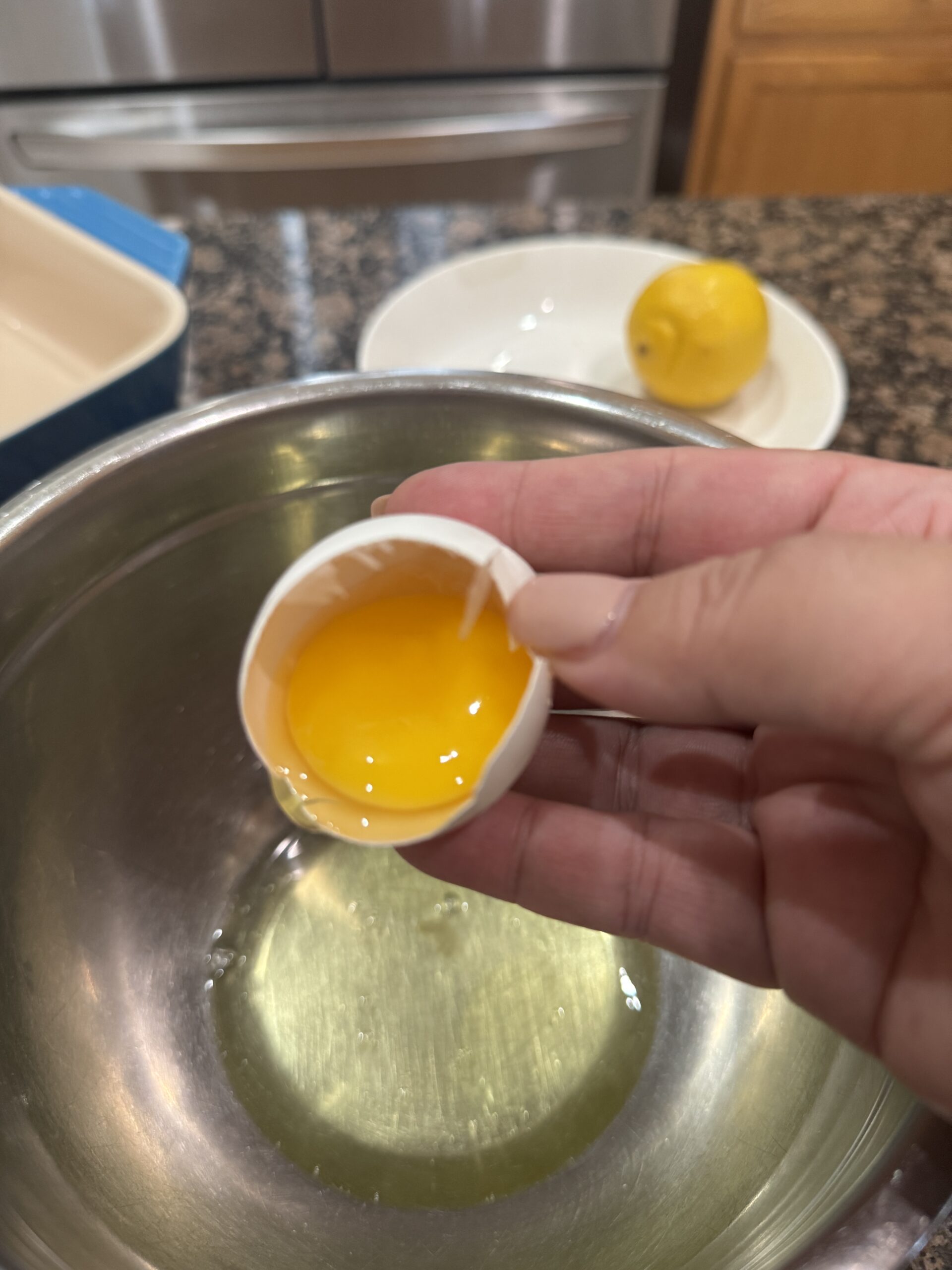 Separating egg yolk from egg white into a bowl