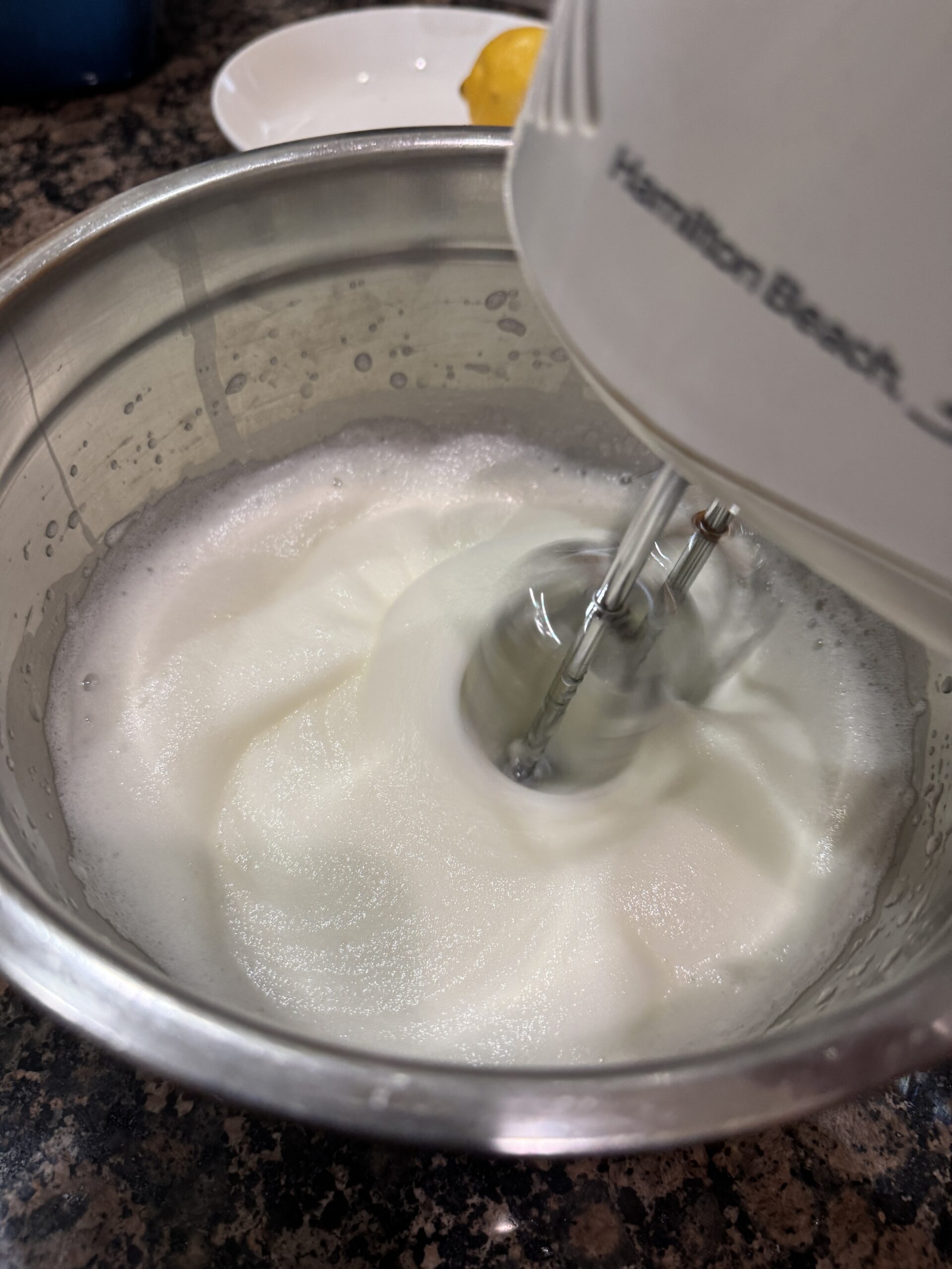 Egg whites being whipped with a hand blender