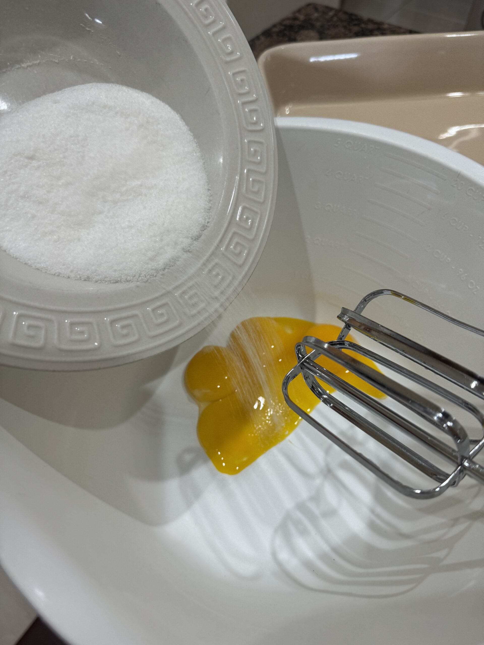 Egg yolks and sugar in a bowl