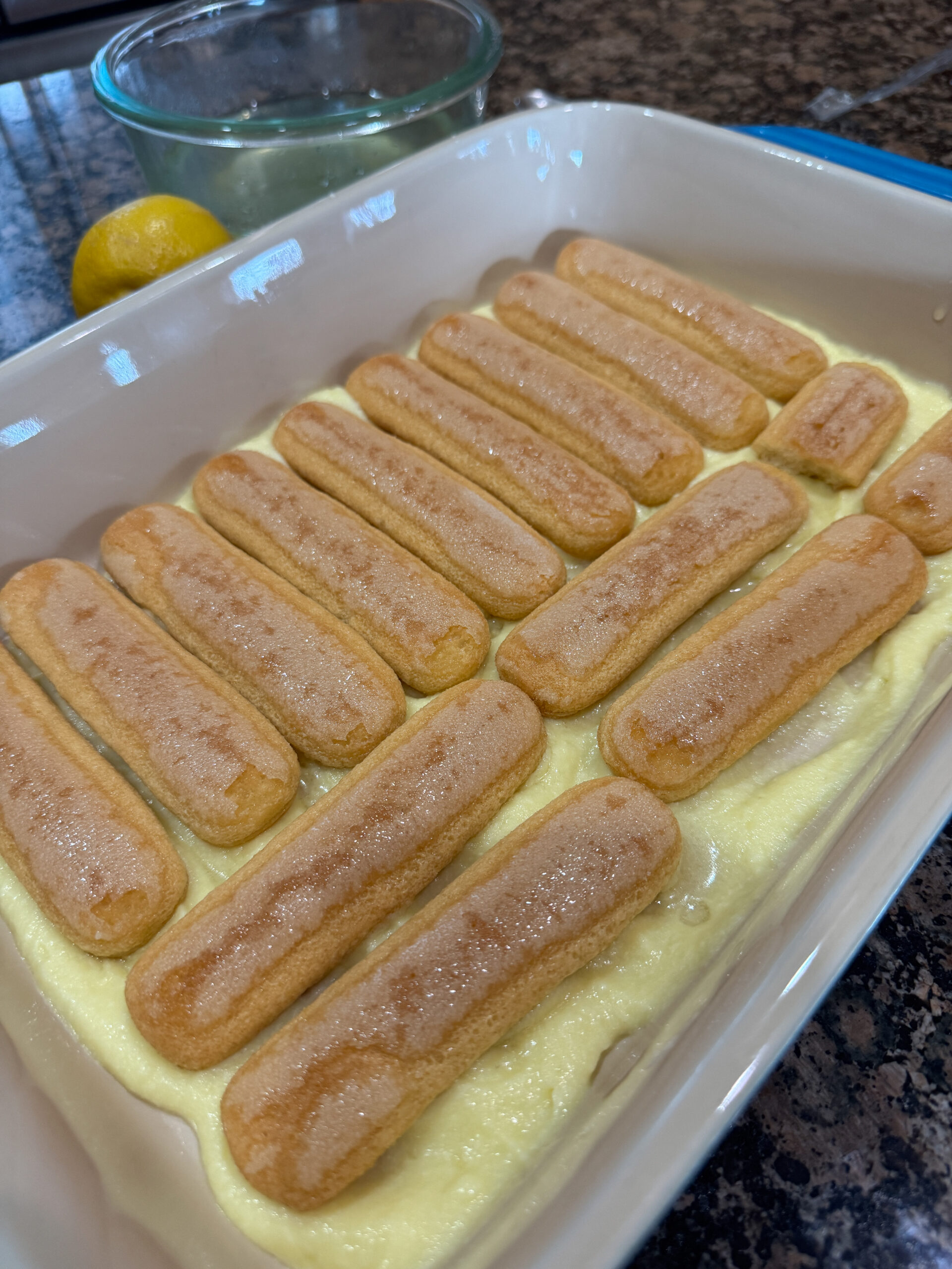 Ladyfingers arranged on top of mascarpone cream