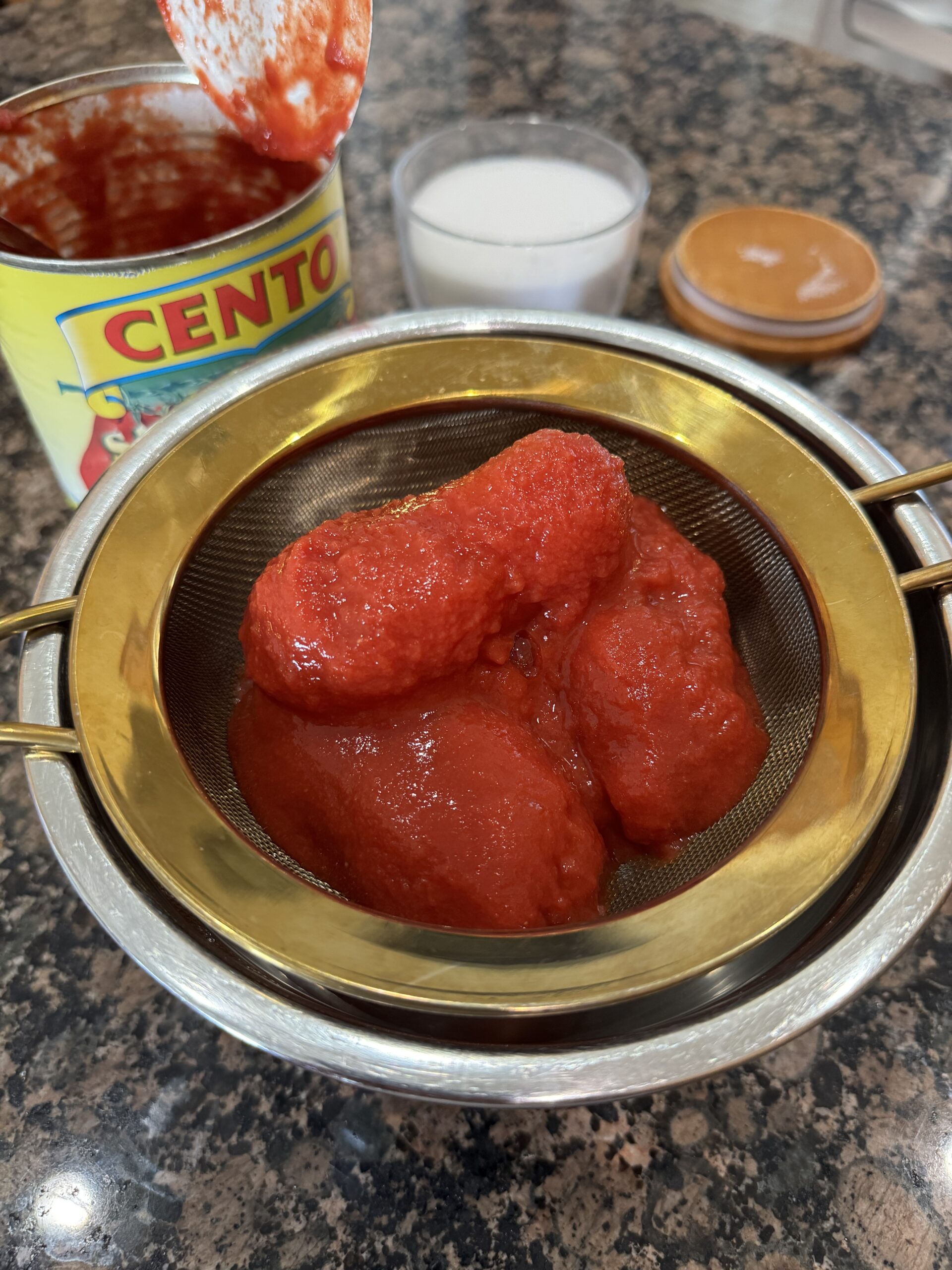 tomatoes in strainer over a bowl