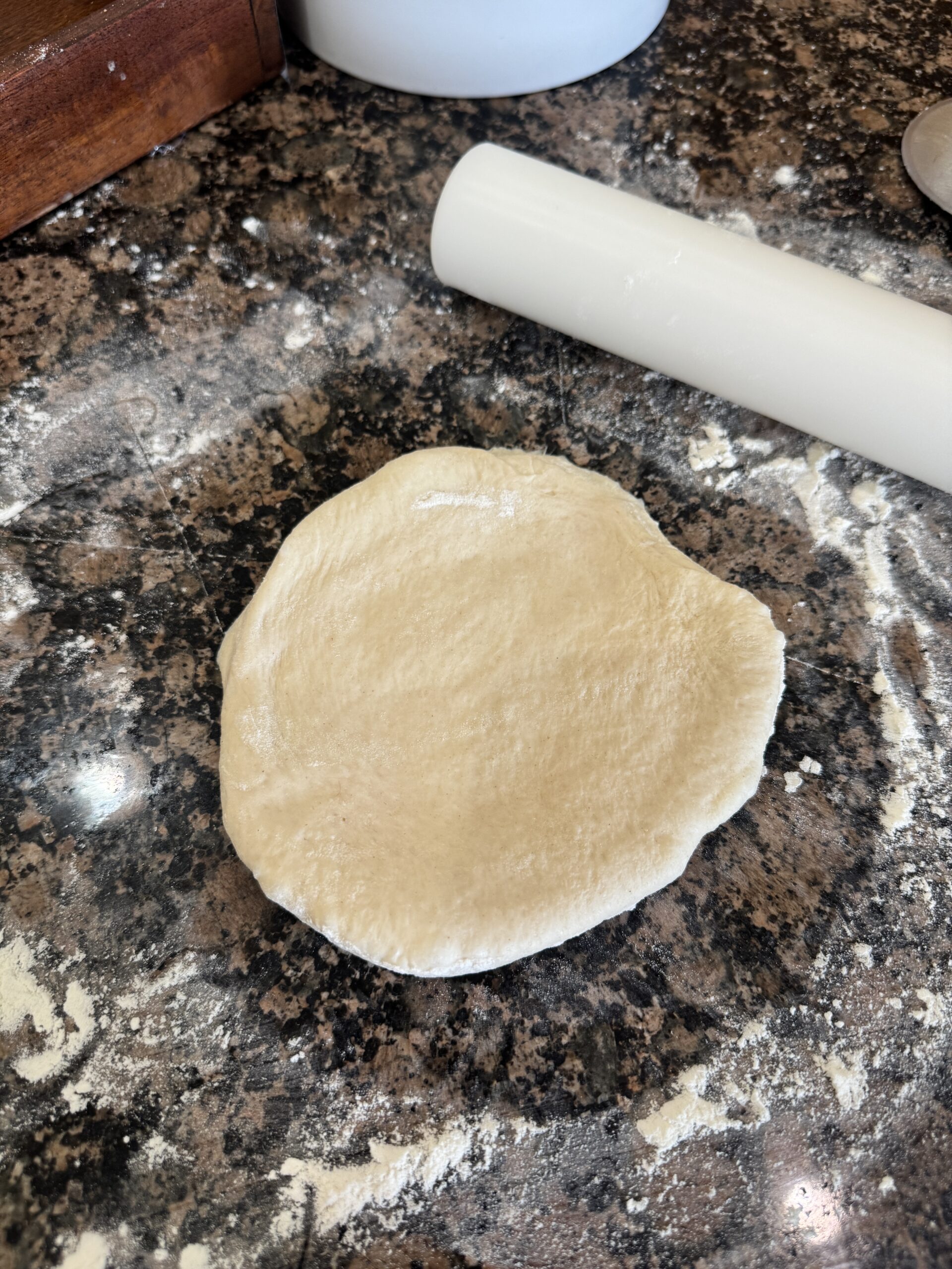 rolling out pizza dough