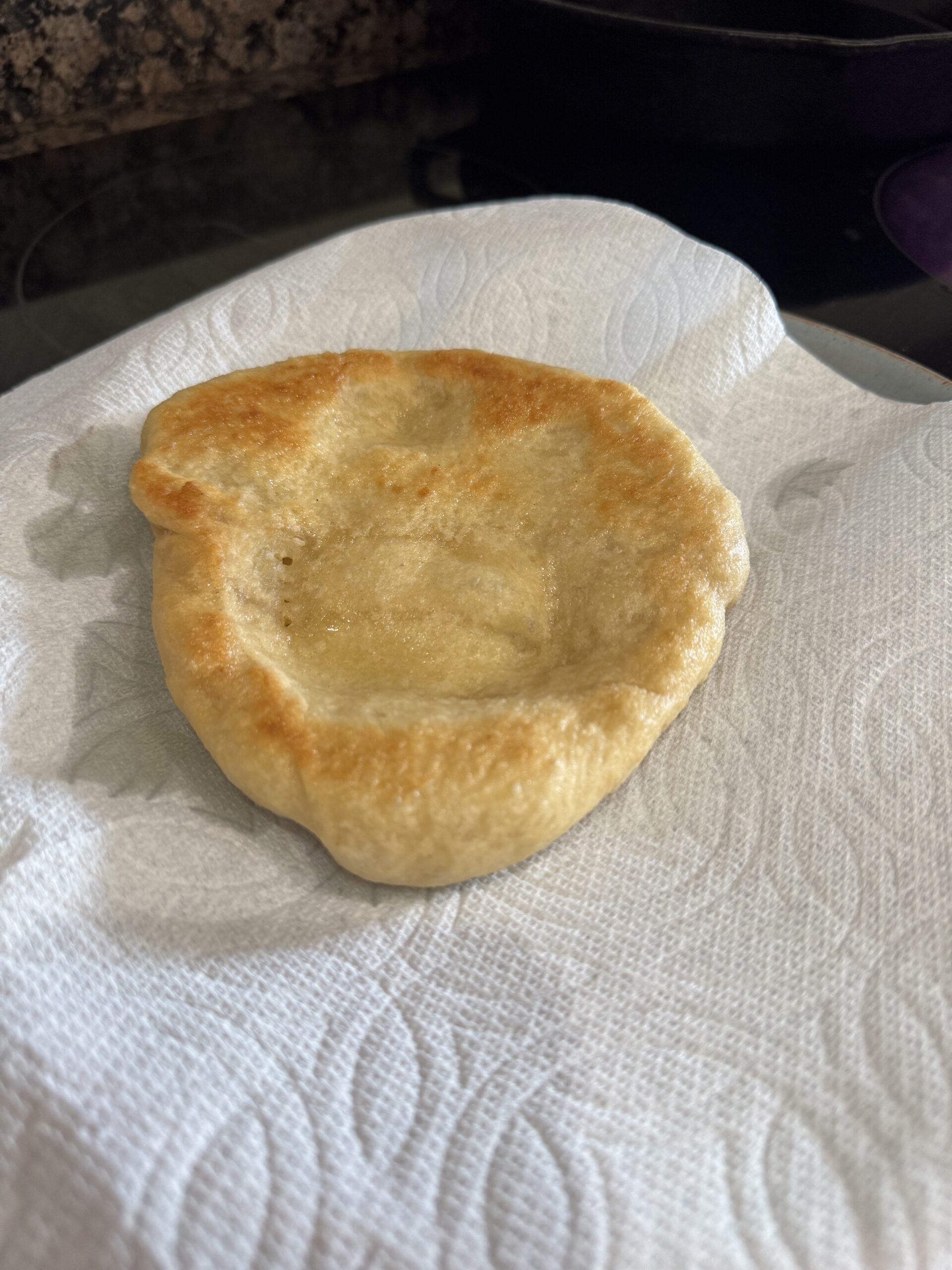 Fried pizza dough on paper towel