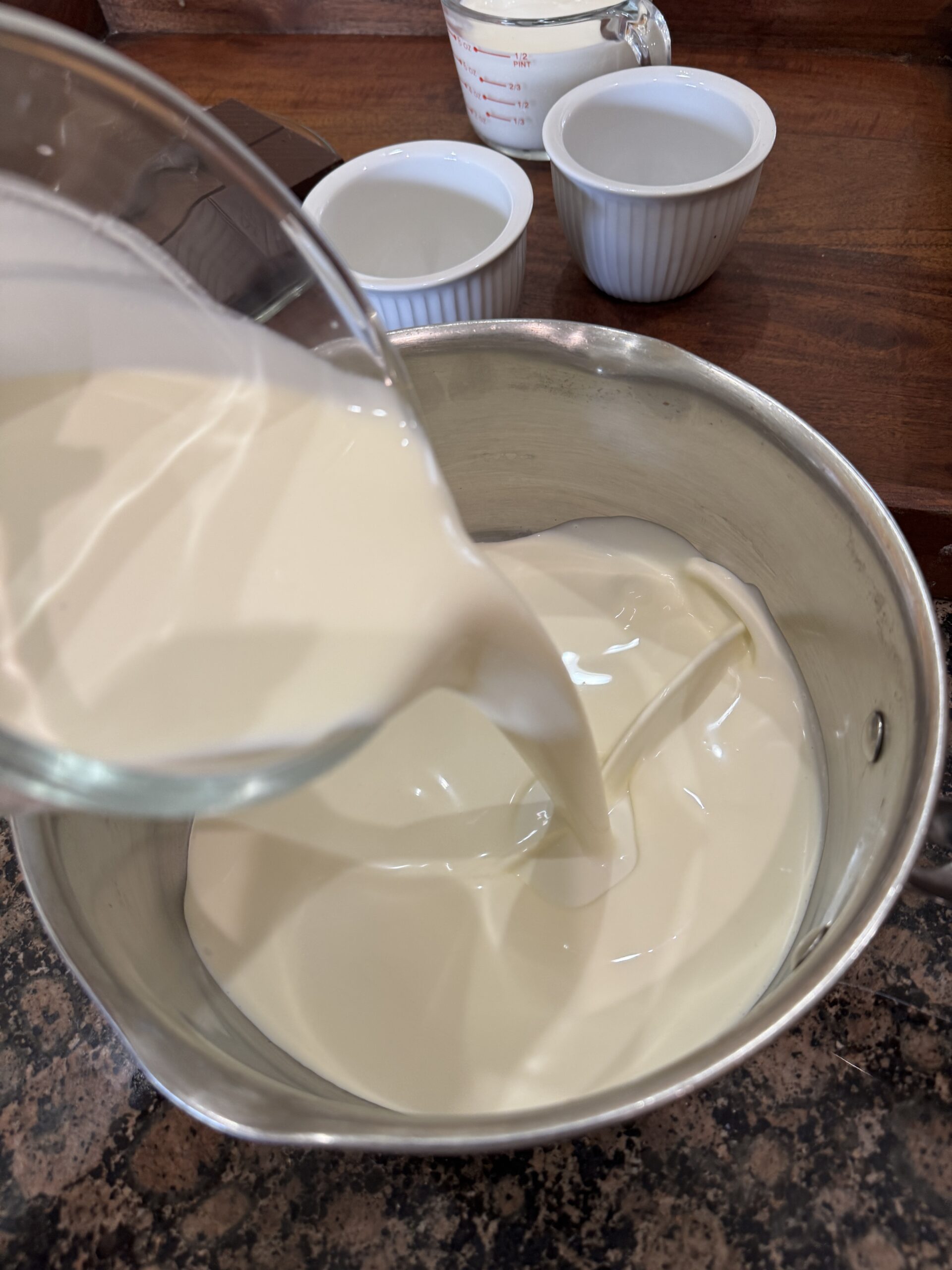 Pouring heavy cream into sauce pan