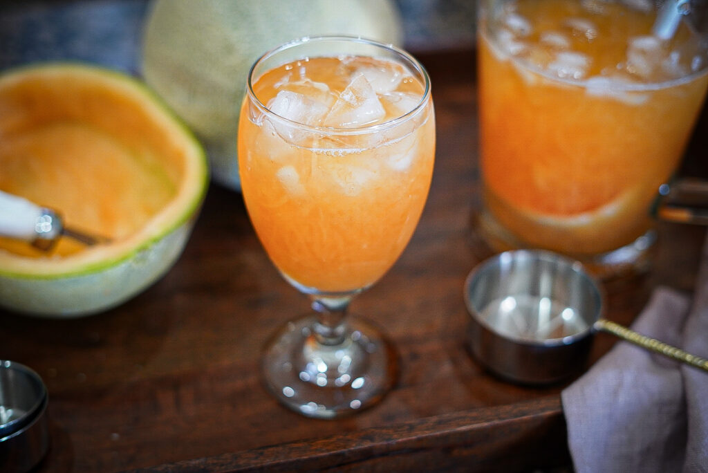 Filipino Cantaloupe Juice in a glass with ice.