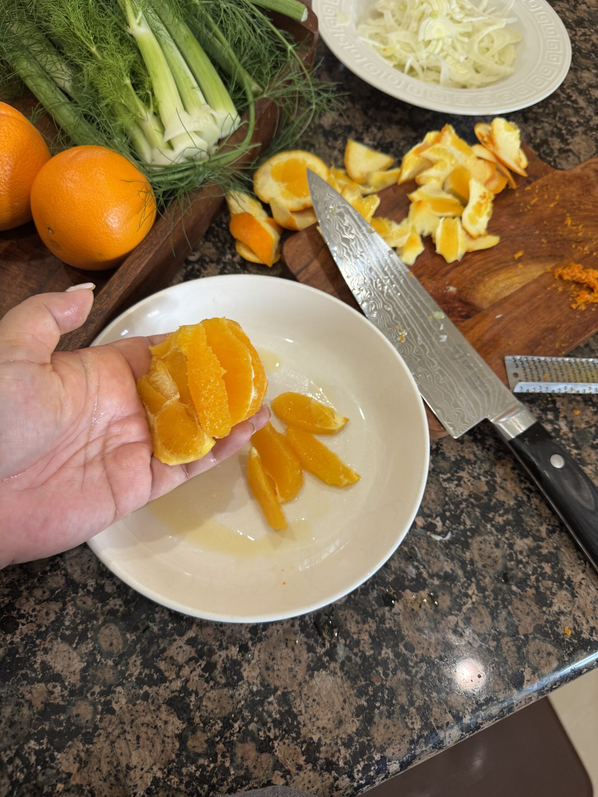 Slicing segments off of a fresh orange.