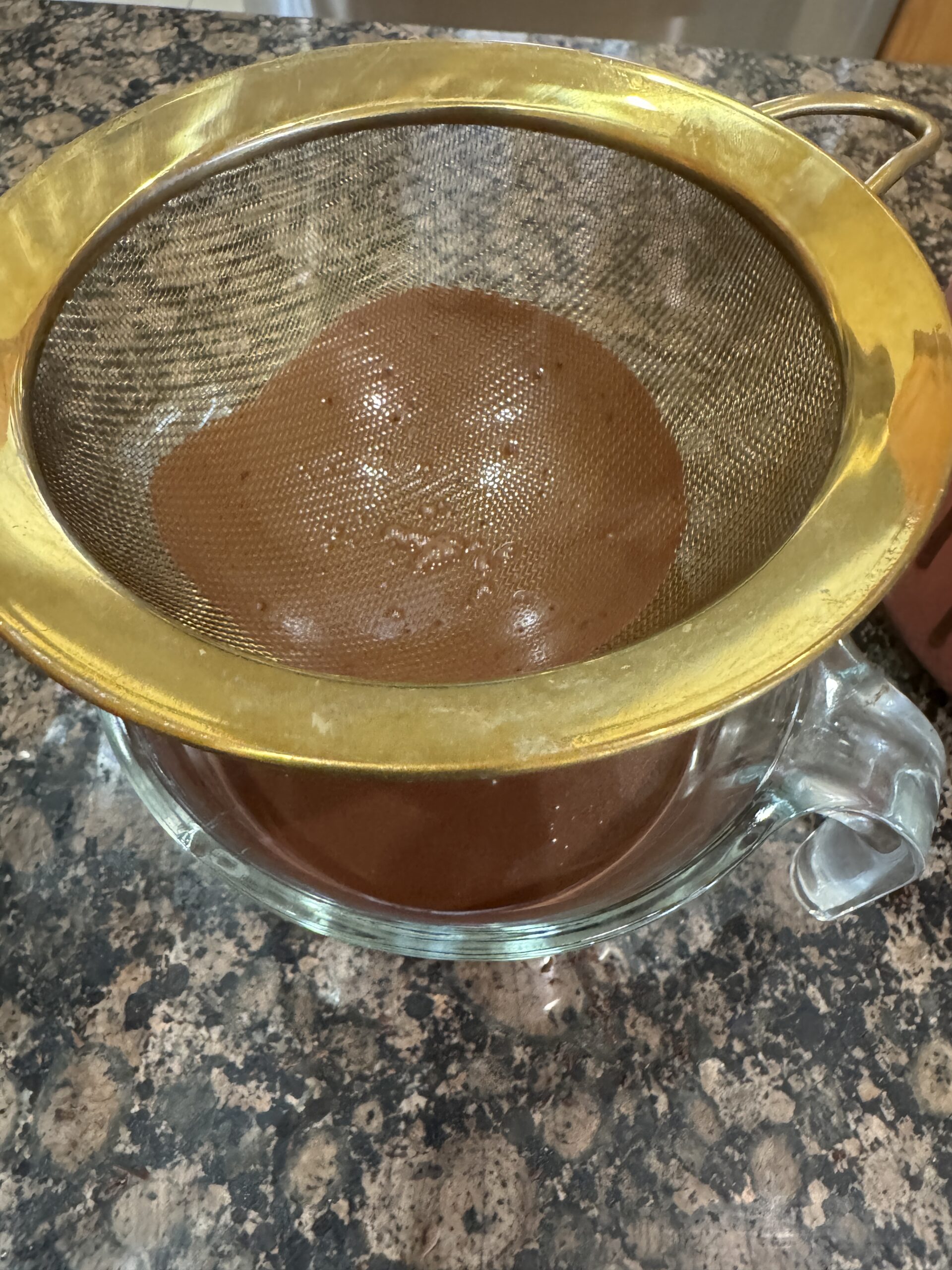 straining chocolate panna cotta mixture