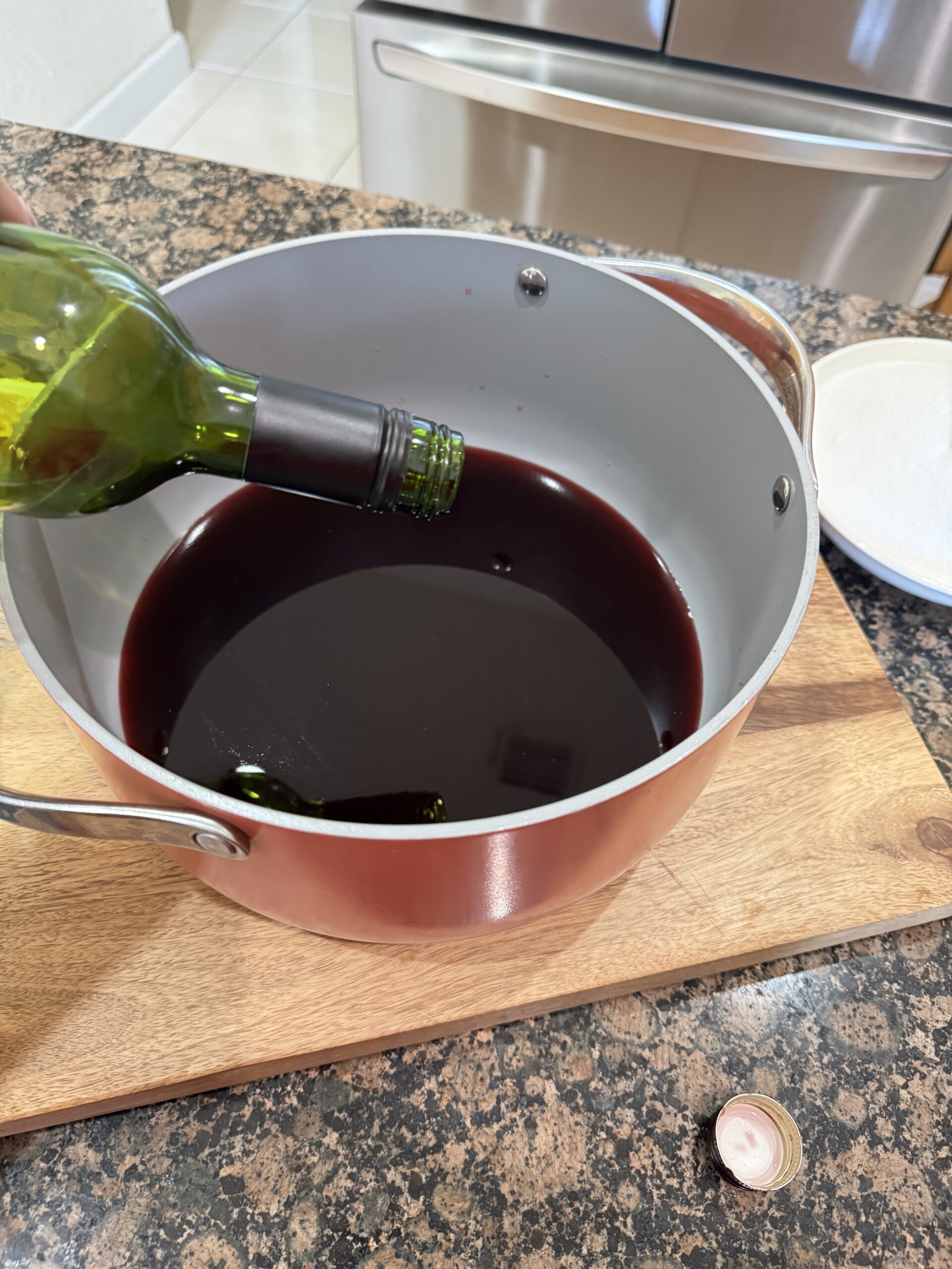 Pouring wine in stock pot